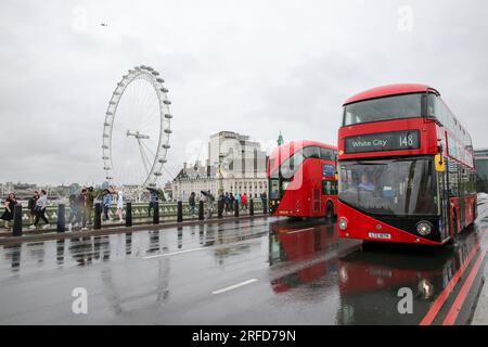 London, UK. 2nd Aug, 2023. People brave the rain on Westminster Bridge in London, Britain, on Aug. 2, 2023. A yellow alert for storms stretching from London to Manchester and covering much of the Midlands and Wales was issued by the Met Office on Wednesday. Credit: Xinhua/Alamy Live News Stock Photo