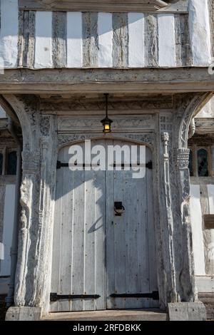 The entrance door to Lavenham Guildhall a magnificent medieval timber framed building in the Suffolk village of Lavenham, Sudbury, Suffolk Stock Photo