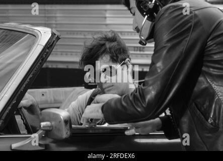 Commedian/Actor Dan Aykroyd on set in 1982. Bernard Gotfryd photograph. Daniel Edward Aykroyd is a Canadian actor, comedian, screenwriter, producer, and musician. Aykroyd was a writer and an original member of the 'Not Ready for Prime Time Players' cast on the NBC sketch comedy series Saturday Night Live from its inception in 1975 until his departure in 1979. During his tenure on SNL, he appeared in a recurring series of sketches, particularly featuring the Coneheads and the Blues Brothers. Stock Photo