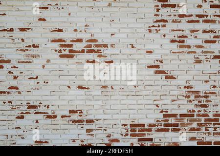 old white paint on red brick wall use as grounge background Stock Photo