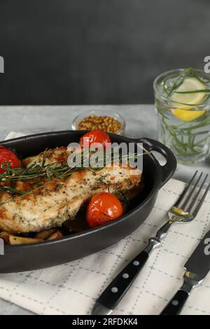 Tasty chicken, vegetables, drink with tarragon and mustard served on grey table Stock Photo