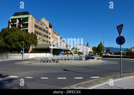 Celje, Slovenia - September 18 2022: Roundabout in the town of Celje in Stajerska, Slovenia with apartment buildings and a water fountain in the middl Stock Photo