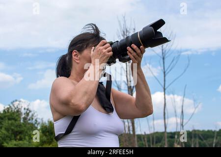 Female photographer with her camera Stock Photo