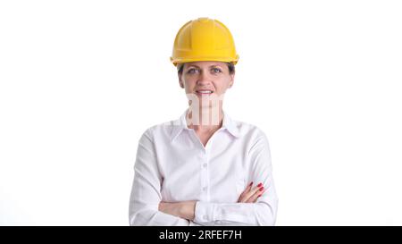 Smiling female architect or engineer in safety helmet Stock Photo