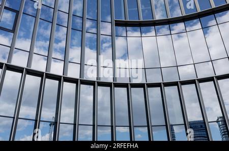 Modern Office Architecture. Close-up of glass facades of office building with sky reflection Stock Photo