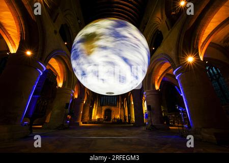 Southwell, UK. 2nd Aug 2023. Luke Jerram's 'Gaia' installation suspended from the ceiling of Southwell Minster.  The seven-metre diameter rotating Gaia features high resolution NASA imagery of the earth's surface. Credit: Neil Squires/Alamy Live News Stock Photo