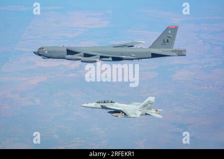 A United States Air Force B-52H Stratofortress and a Royal Australian Air Force F/A-18F Super Hornet fly during Talisman Sabre 23. Courtesy Photo Stock Photo