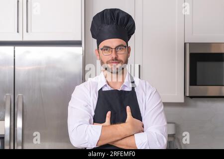 Bearded man cook wear chef hat and uniform. Male chef, cook, baker in  uniform holds saucepan