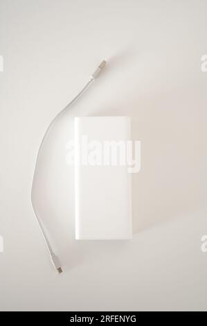 White power bank with white cord cable isolated. White background. Stock Photo