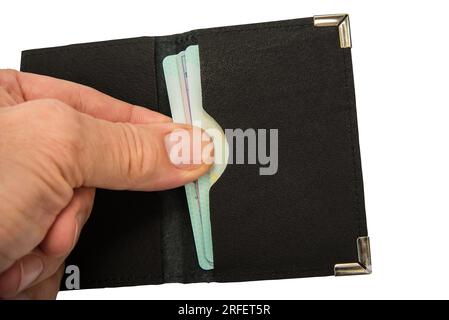 Man pulls out a credit card from a leather case Stock Photo