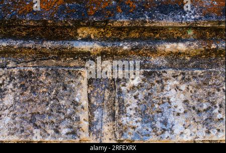 Detail of an old stone wall with lots of texture and warm, blue tones. Texture and template concept. Stock Photo