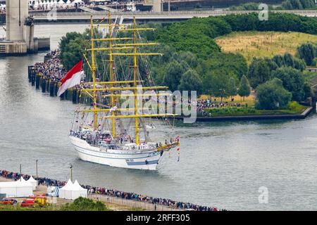 France, Seine-Maritime, Canteleu, Armada 2023, elevated view of Rouen and departure of Indonesian tall ship Bima Suci, with sailors manning the yards and lines of spectators by the Seine river Stock Photo