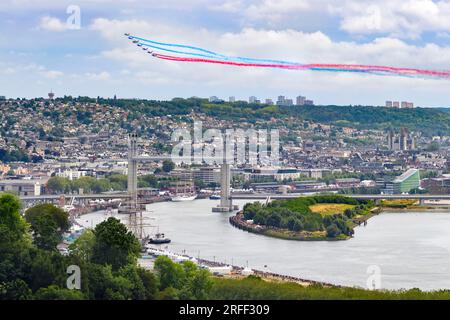France, Seine-Maritime, Canteleu, Armada 2023, elevated view of Rouen and Gustave Flaubert Bridge, French Acrobatic Patrol (PAF) performance, with traces of tricolor smoke behind the Alpha Jets Stock Photo