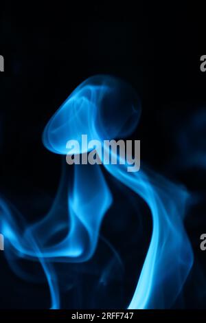 Blue  smoke on a dark background, patterns, vertical Stock Photo