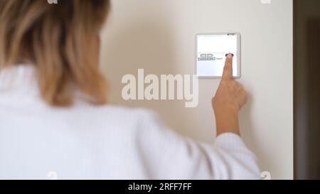 Wall mounted digital climate control and home thermostat Stock Photo