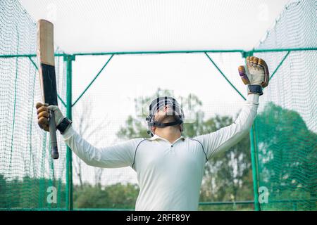 Cricket batsman celebrating his success and feeling happy Stock Photo