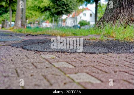 Poorly repaired bicycle lane with a bumpy edge in Berlin, Germany Stock ...