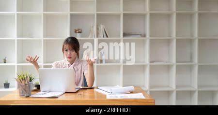 Asian business woman got stressed at work during in the office room, stressed face while working Stock Photo