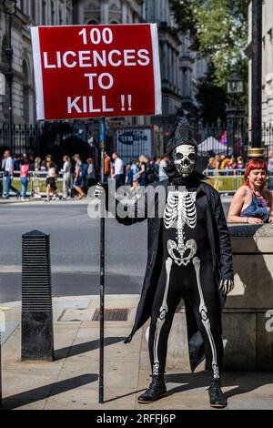 London, UK. 3rd Aug, 2023. Death gets his message across - Our Leaders Fiddle While Rhodes Burns Action by Extinction Rebellion outside Downing Street. It is in protest to Prime Minister Rishi Sunak allowing new North Sea Oil and Gas licences. Credit: Guy Bell/Alamy Live News Stock Photo
