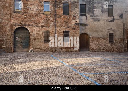 Wooden  doors of buildings on a cobbled street in an italian town at sunset Stock Photo