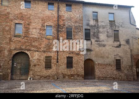 Wooden  doors of buildings on a cobbled street in an italian town at sunset Stock Photo