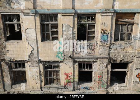Facade of an old dilapidated building with broken windows Stock Photo