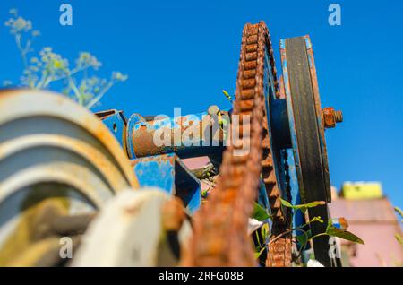 Rusty chain on gears of old mechanism, motor. Stock Photo