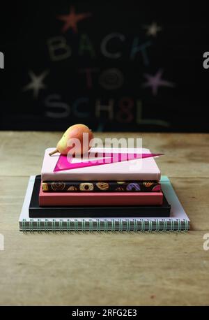 a back to school still life with books, ruller and a pear Stock Photo