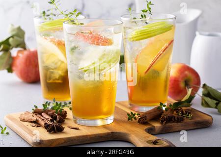 Refreshing fall apple cocktails with cinnamon and thyme garnished with apple slices Stock Photo