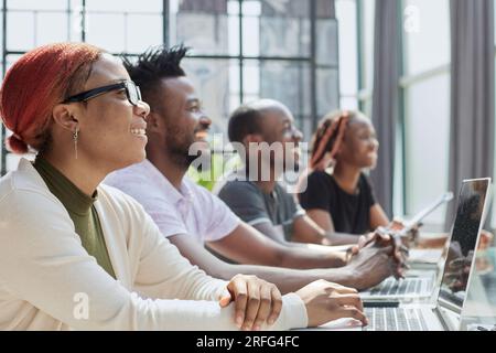 young employee working with headset and looking at monitor Stock Photo