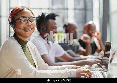 call center agents smiling happy working at the office. Stock Photo