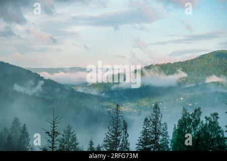 Wonderful countryside with fog under sunlight. Fog over the mountains. Unsurpassed misty morning in the mountains during sunrise. Amazing nature Stock Photo