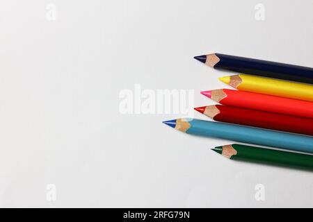 a bunch of coloring pencils on a white paper background Stock Photo