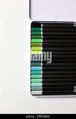 a set of coloring pencils in a white tin box on a white background Stock Photo