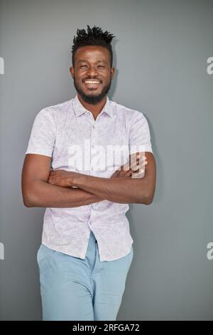 Serious dark skinned businessman has strict look, contemplates about new business project Stock Photo