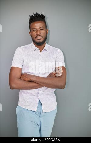Serious dark skinned businessman has strict look, contemplates about new business project Stock Photo