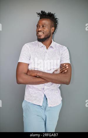 Serious dark skinned businessman has strict look, contemplates about new business project Stock Photo