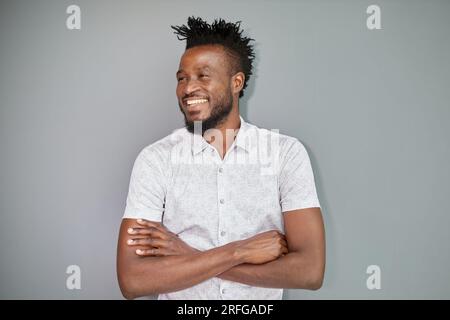 Serious dark skinned businessman has strict look, contemplates about new business project Stock Photo
