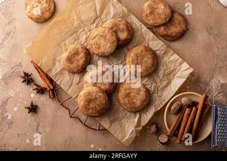 Cinnamon cookies tossed with cinnamon sugar on a parchment paper with milk, classic snickerdoodle cookies Stock Photo