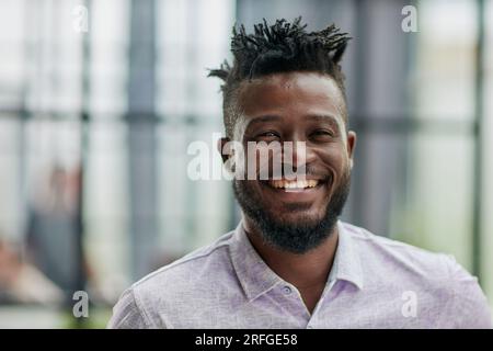 Serious dark skinned businessman has strict look, contemplates about new business project Stock Photo