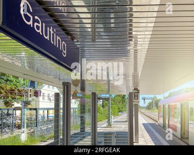 Gauting, DE, May 22, 2022: Gauting train station platform, with a train in the background Stock Photo