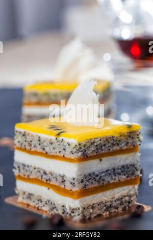 multi layered cake with cakes, fruit peach jelly, poppy seeds and cottage cheese, delicious multi layered dessert Stock Photo