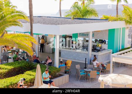 View of hotel guests in outdoor pool restaurant on hot summer day. Gran Canaria, Spain. Stock Photo