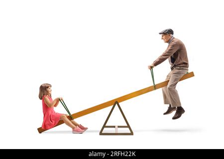 Little girl playing on a seesaw with her grandfather isolated on white background Stock Photo