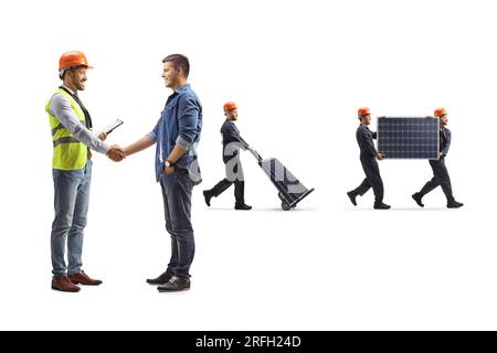 Engineer shaking hand with a young man and workers carrying solar panels isolated on white background Stock Photo