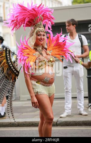 London, UK. 29 Aug 2022. A pregnant dancer at the Notting Hill Carnival. The biggest street party in Europe. Credit: Waldemar Sikora Stock Photo