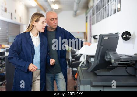 Man and woman working in printshop Stock Photo
