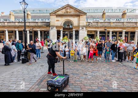 Australian magician Jason Maher performs and entertains a crowd in Covent Garden in London's West End, WC2 Stock Photo