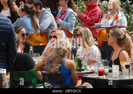 Groups of all ages enjoying leisure time at a bar restaurant outdoor space in Valletta, Malta, April 2022. Stock Photo