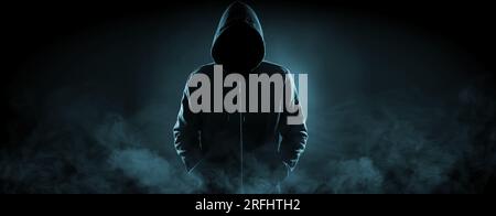 Anonymous man in hood surrounded by smoke on black background. Banner design Stock Photo